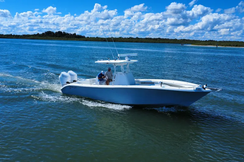 Slide: The Image of 2010 Yellowfin 32 Offshore boat cruising on a sunny day with blue skies and calm waters. - 9