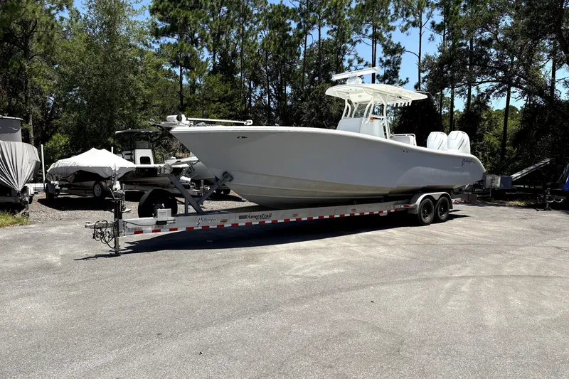 Slide: The Image of 2010 Yellowfin 32 Offshore boat on trailer in wooded area. - 44