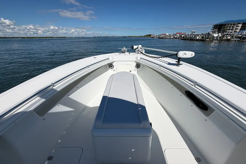 Slide: The Image of 2010 Yellowfin 32 Offshore boat on calm water, clear sky, and distant shoreline. - 15