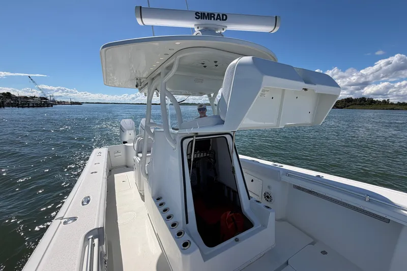 Slide: The Image of 2010 Yellowfin 32 Offshore boat on water, featuring Simrad electronics and spacious deck. - 20