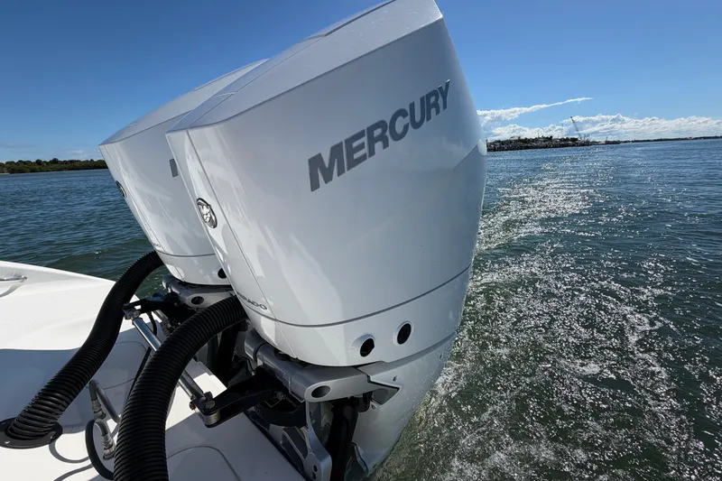 Slide: The Image of Twin Mercury outboard engines on a 2010 Yellowfin 32 Offshore boat cruising on water. - 29