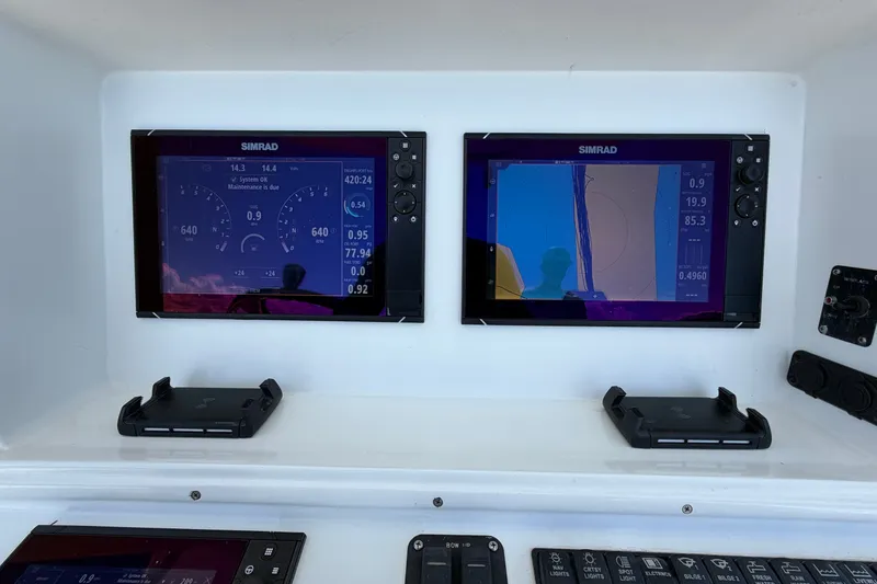Slide: The Image of Simrad navigation displays on 2010 Yellowfin 32 Offshore boat dashboard. - 36
