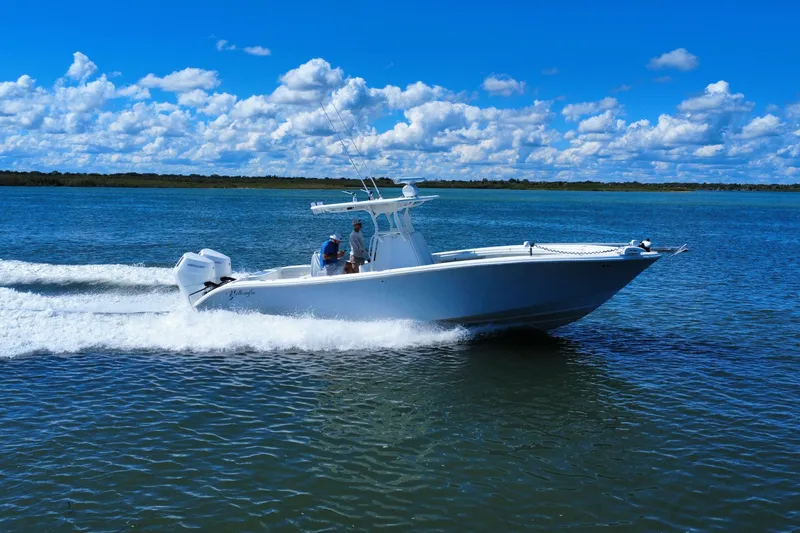 Slide: The Image of 2010 Yellowfin 32 Offshore boat cruising on a sunny day with blue skies. - 2