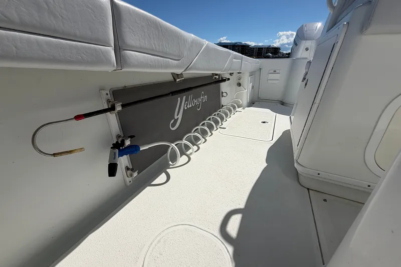 Slide: The Image of 2010 Yellowfin 32 Offshore boat interior with fishing rod holder and clean deck. - 40