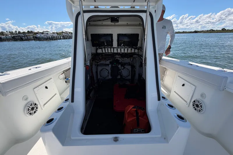 Slide: The Image of 2010 Yellowfin 32 Offshore boat interior with open hatch, docked by the water. - 21