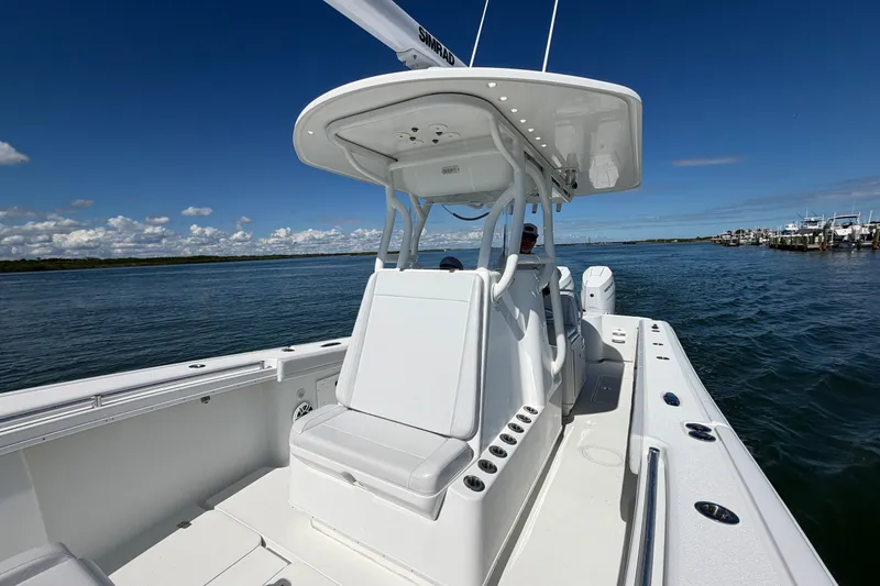 Slide: The Image of 2010 Yellowfin 32 Offshore boat on calm water under clear blue sky. - 42