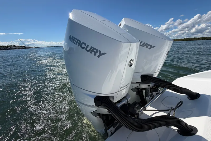 Slide: The Image of Twin Mercury outboard engines on a 2010 Yellowfin 32 Offshore boat, cruising on open water. - 30