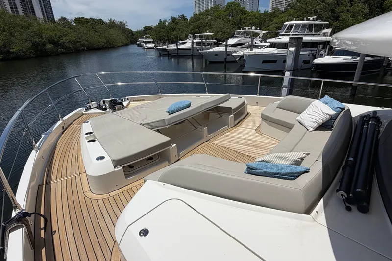 Slide: The Image of Luxurious 2024 Absolute Navetta 75 yacht deck with plush seating and scenic marina view. - 18