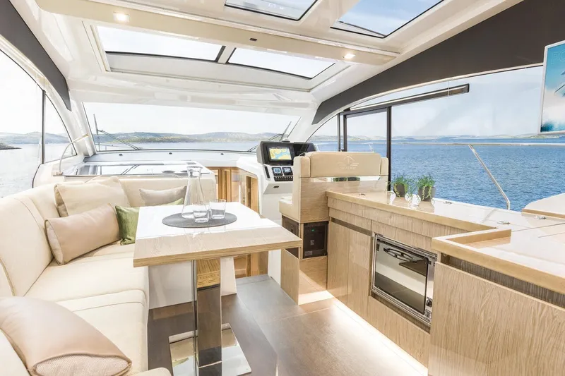 Slide: The Image of Innenraum einer modernen Yacht mit hellem Holz, großen Fenstern und komfortablen Sitzgelegenheiten. - 26