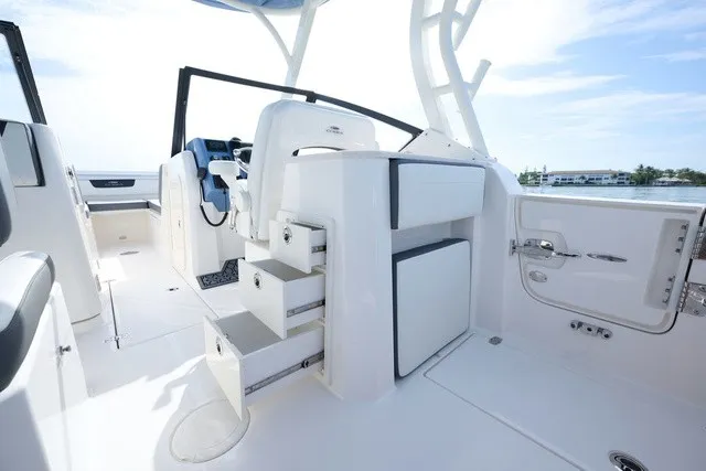Slide: The Image of The image shows the cockpit of a 2027 Cobia 250 DC with white seating and storage. - 15