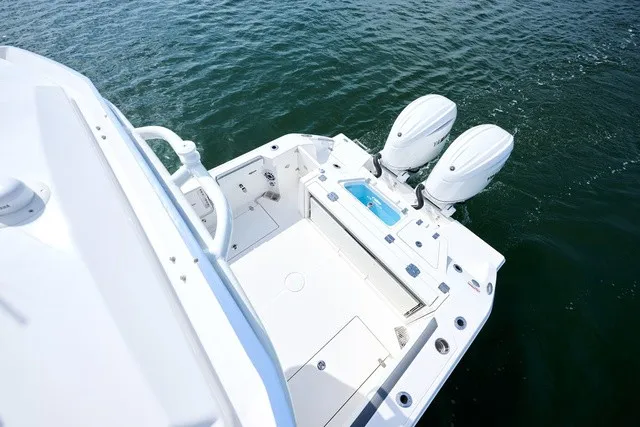 Slide: The Image of The image shows the stern of a Cobia 250 DC boat with two outboard engines. - 20