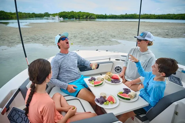 Slide: The Image of Family enjoying a picnic on a Cobia 250 DC boat. - 24