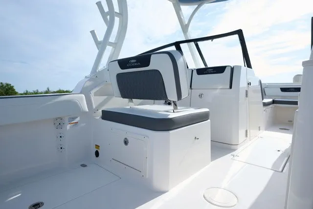 Slide: The Image of The image shows the cockpit of a 2027 Cobia 250 DC with modern seating and helm console. - 14