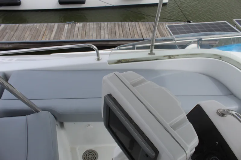 Slide: The Image of Cockpit view of 2004 Lagoon Power 43 yacht with seating and control panel. - 13