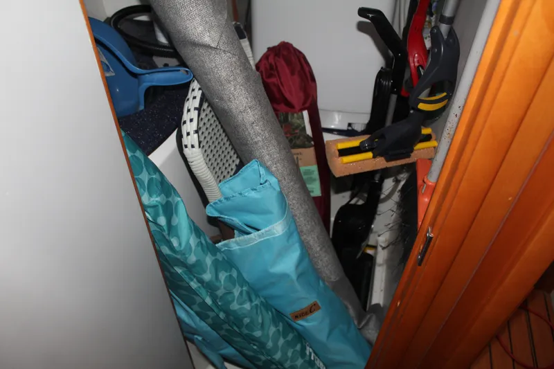 Slide: The Image of Storage area on a 2004 Lagoon Power 43 boat with cleaning supplies and equipment. - 60
