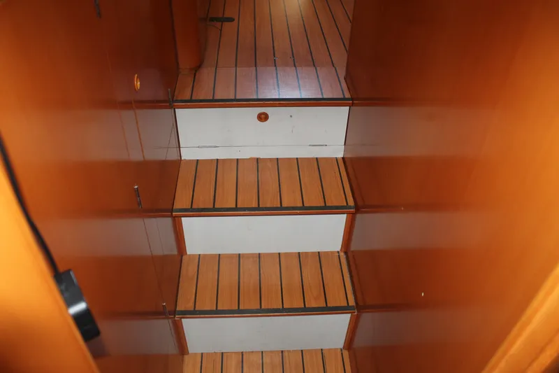 Slide: The Image of Wooden staircase inside 2004 Lagoon Power 43 yacht, featuring sleek, polished finish. - 40