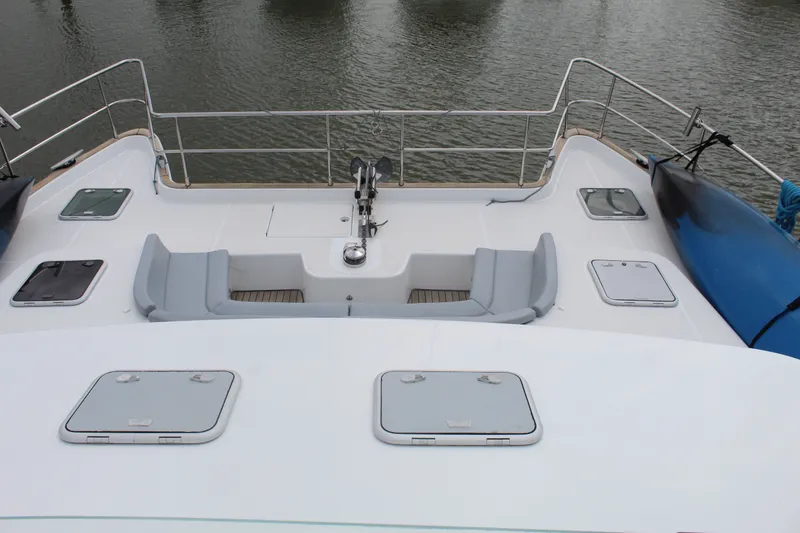 Slide: The Image of 2004 Lagoon Power 43 yacht deck with seating and storage compartments. - 19