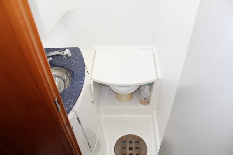 Slide: The Image of Compact bathroom in 2004 Lagoon Power 43 yacht with sink and toilet. - 54