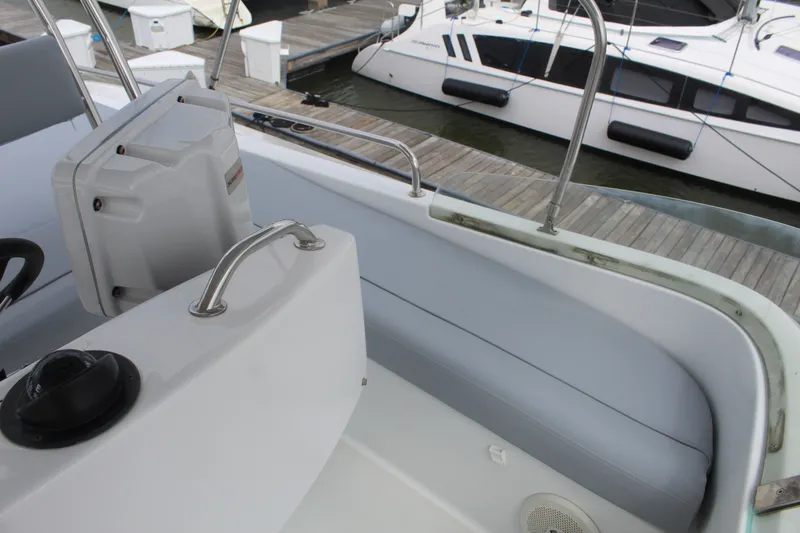 Slide: The Image of Cockpit view of 2004 Lagoon Power 43 yacht at marina, showcasing seating and helm. - 17
