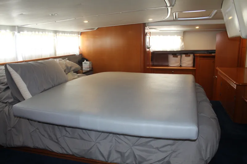 Slide: The Image of Luxurious cabin interior of 2004 Lagoon Power 43 yacht with spacious bed and elegant wood finish. - 56