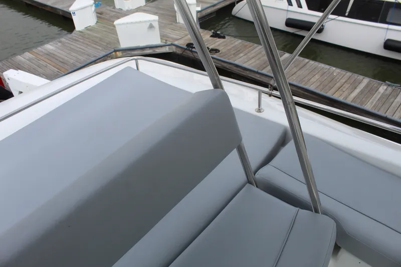 Slide: The Image of 2004 Lagoon Power 43 boat with gray seating at a marina dock. - 14