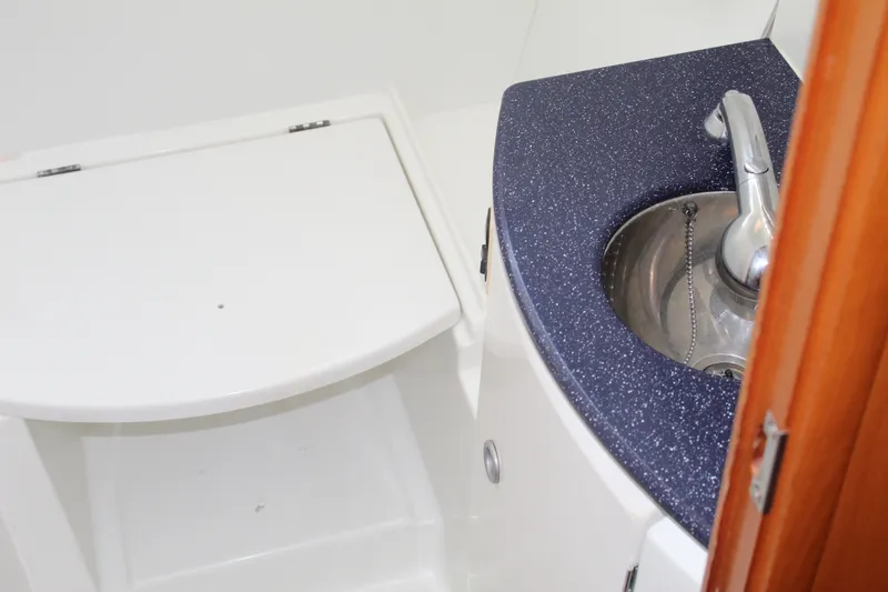 Slide: The Image of Compact bathroom sink and toilet in 2004 Lagoon Power 43 yacht. - 50