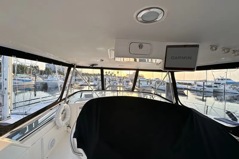 Slide: The Image of Interior view of 2003 Sea Ray 480 Sedan Bridge yacht at marina during sunset. - 3