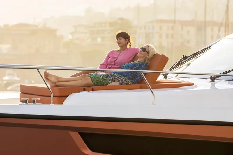 Slide: The Image of Two people relaxing on a 2026 Sealine C430 yacht deck. - 17