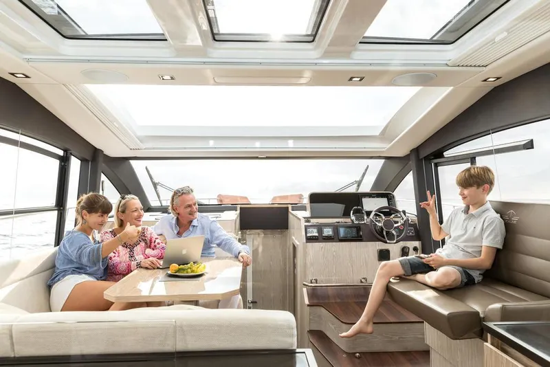 Slide: The Image of Family enjoying leisure time on 2026 Sealine C430 yacht interior. - 13