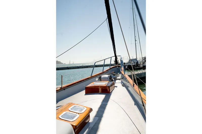 Slide: The Image of 1981 Thackwray Motorsailor yacht deck with wooden accents, docked by the water. - 31
