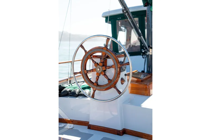 Slide: The Image of Wooden steering wheel on 1981 Thackwray Motorsailor yacht, with polished metal accents. - 40
