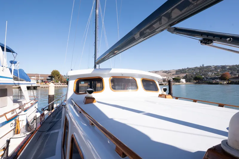 Slide: The Image of 1981 Thackwray Motorsailor docked, showcasing sleek design and waterfront view. - 17