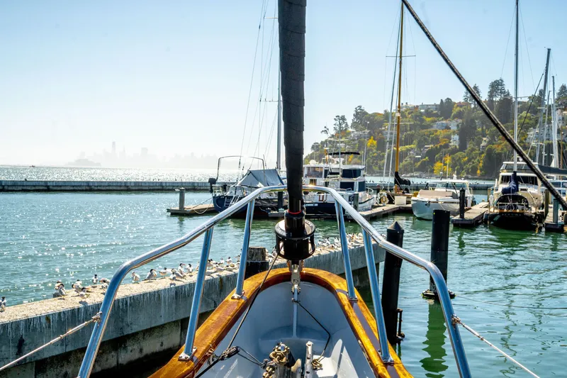 Slide: The Image of 1981 Thackwray Motorsailor docked in scenic marina with city skyline in background. - 43