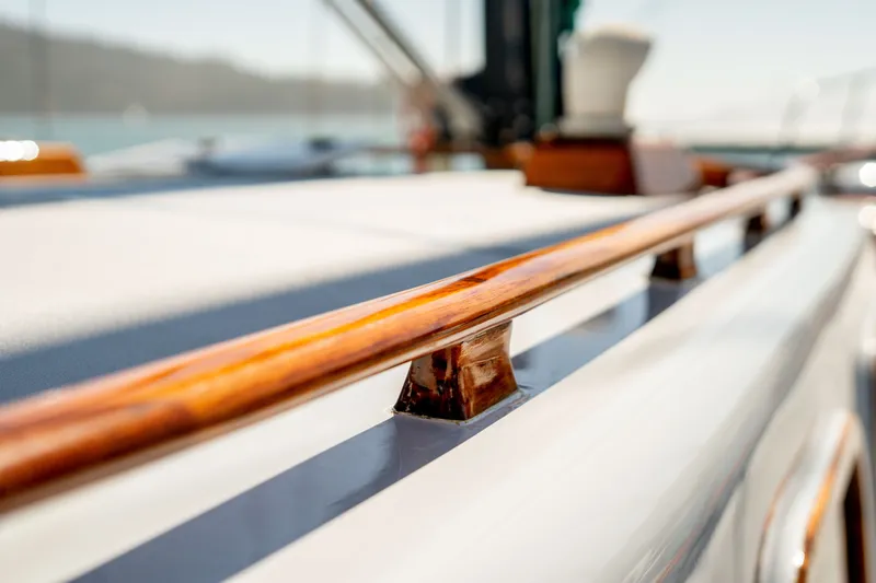 Slide: The Image of Polished wooden railing on 1981 Thackwray Motorsailor yacht deck, close-up view. - 47