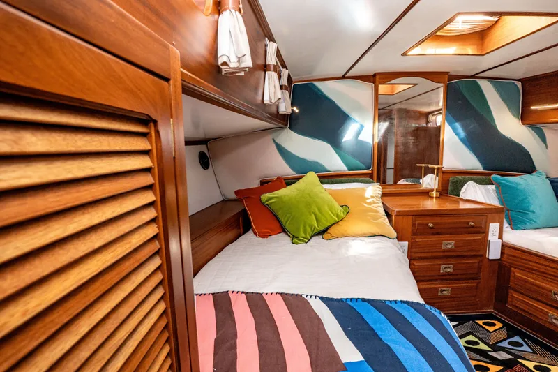 Slide: The Image of Cozy cabin interior of 1981 Thackwray Motorsailor with colorful pillows and wooden furnishings. - 99