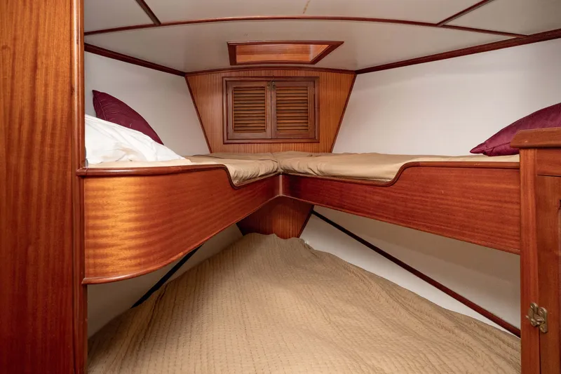 Slide: The Image of Cozy wooden cabin interior of 1981 Thackwray Motorsailor with twin beds and storage. - 88