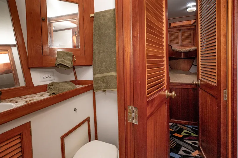 Slide: The Image of Interior of 1981 Thackwray Motorsailor with wooden cabinetry and cozy sleeping quarters. - 86