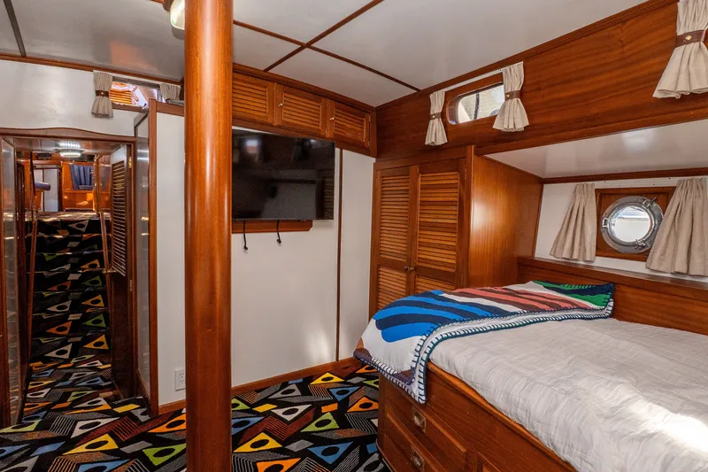 Slide: The Image of Interior of 1981 Thackwray Motorsailor with wooden furnishings and colorful carpet. - 97