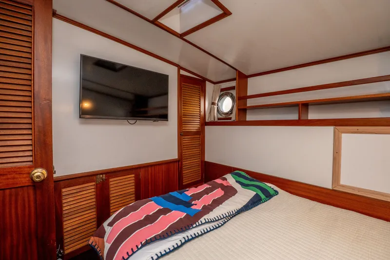 Slide: The Image of Cozy cabin interior of 1981 Thackwray Motorsailor with TV and colorful bedding. - 112