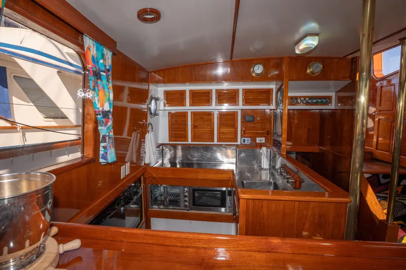 Slide: The Image of Interior of 1981 Thackwray Motorsailor yacht with wooden cabinetry and stainless steel kitchen. - 123