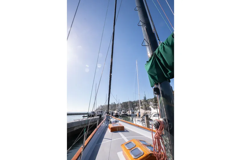 Slide: The Image of 1981 Thackwray Motorsailor yacht docked at marina under clear blue sky. - 20