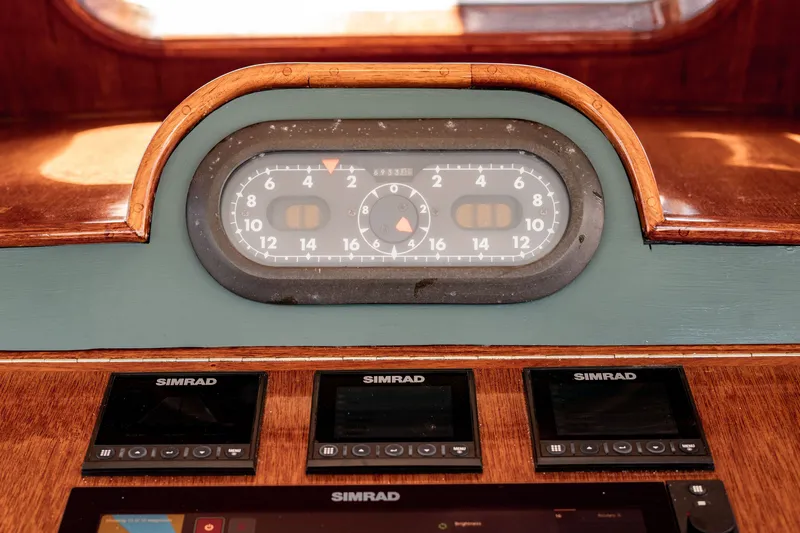 Slide: The Image of Dashboard of a 1981 Thackwray Motorsailor with navigation instruments and Simrad displays. - 55