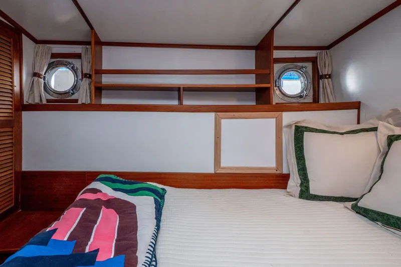 Slide: The Image of Cozy cabin interior of 1981 Thackwray Motorsailor with portholes and colorful bedding. - 111