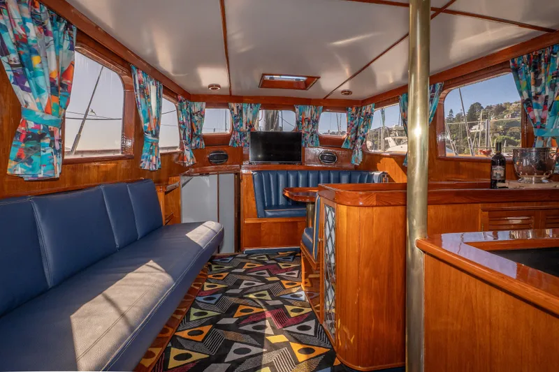 Slide: The Image of Interior of 1981 Thackwray Motorsailor with vibrant curtains and cozy seating area. - 117