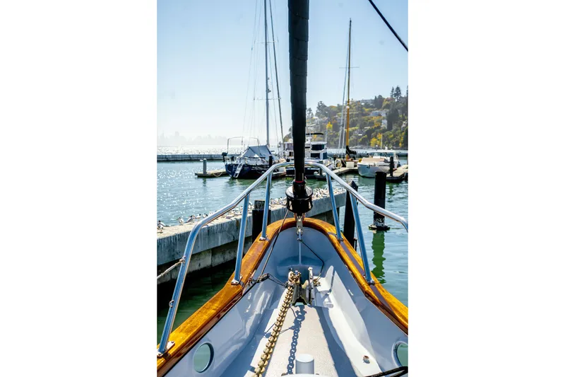 Slide: The Image of 1981 Thackwray Motorsailor docked at a sunny marina, showcasing its polished deck and mooring chain. - 44