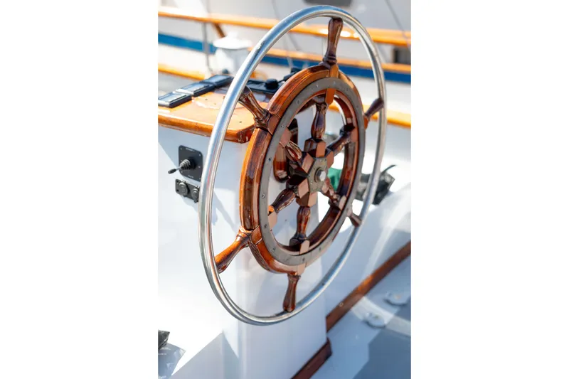 Slide: The Image of Wooden steering wheel on 1981 Thackwray Motorsailor yacht, showcasing nautical craftsmanship. - 39