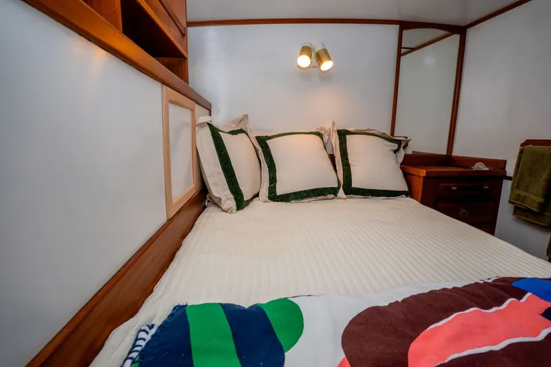 Slide: The Image of Cozy cabin bedroom in 1981 Thackwray Motorsailor with wooden accents and soft lighting. - 96
