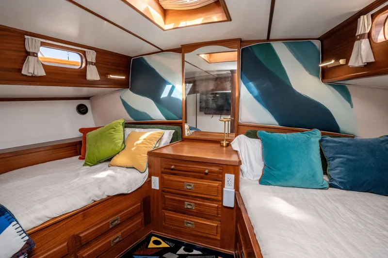 Slide: The Image of Interior of 1981 Thackwray Motorsailor with cozy twin beds and colorful cushions. - 106