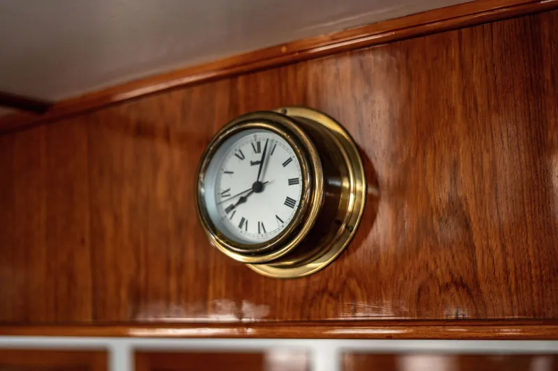 Slide: The Image of Brass clock on wooden panel inside 1981 Thackwray Motorsailor yacht. - 61