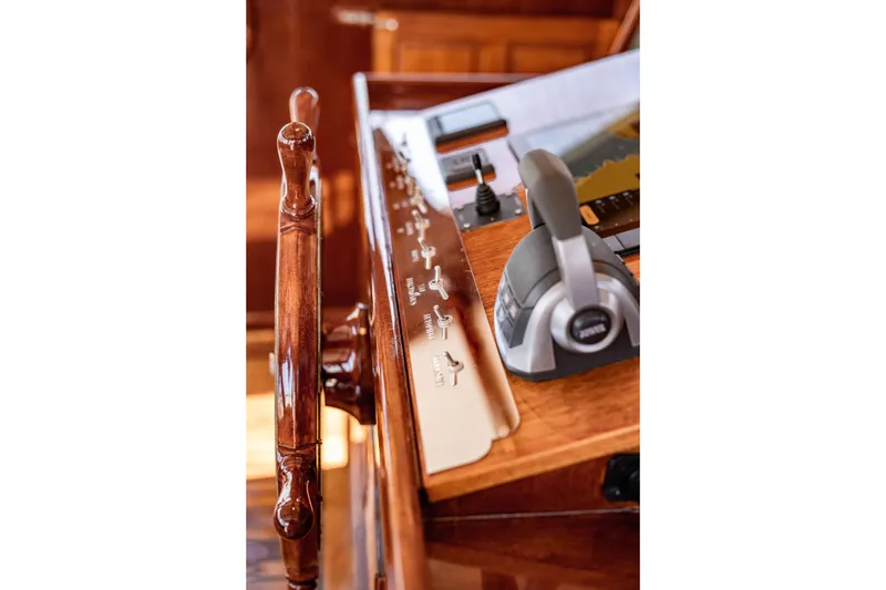 Slide: The Image of Wooden helm and controls of a 1981 Thackwray Motorsailor yacht. - 49